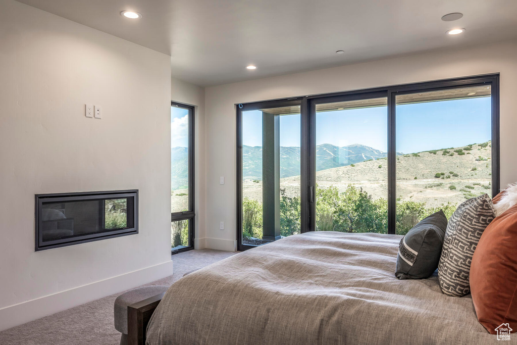 Bedroom featuring a mountain view and light colored carpet