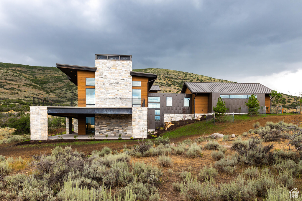 Back of property featuring a mountain view