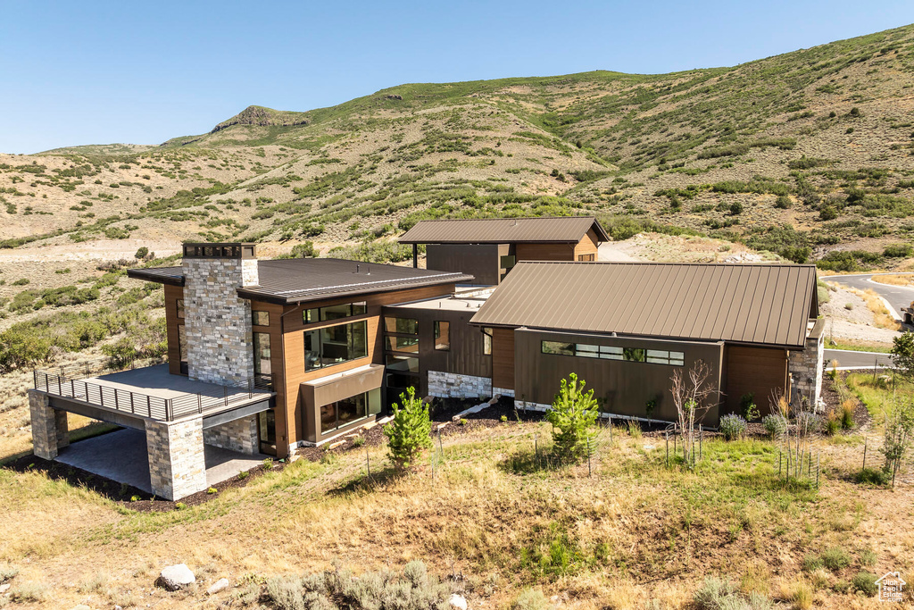 Rear view of property featuring a mountain view