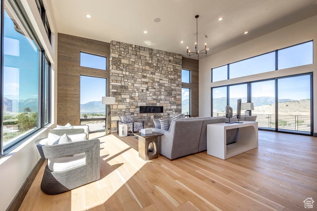 Living room with a fireplace, a mountain view, and light hardwood / wood-style flooring