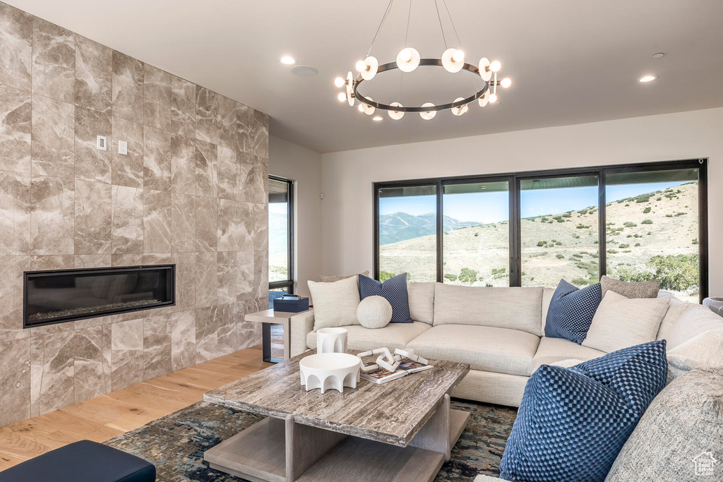 Living room with a healthy amount of sunlight, a mountain view, and a chandelier