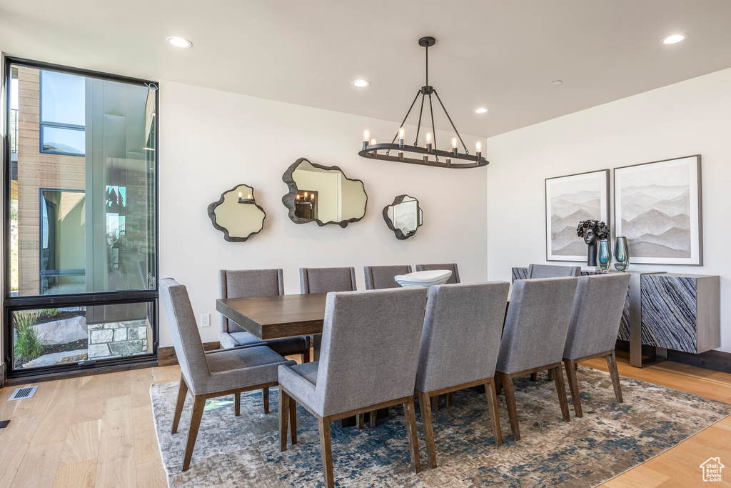 Dining room featuring a notable chandelier and hardwood / wood-style flooring