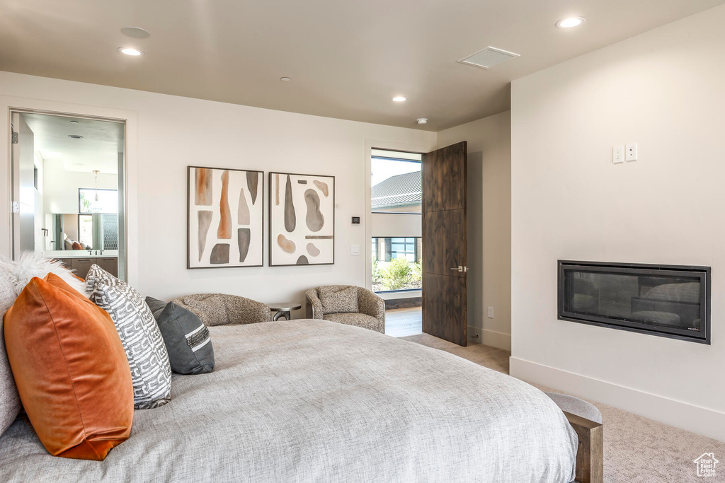 Bedroom featuring light carpet