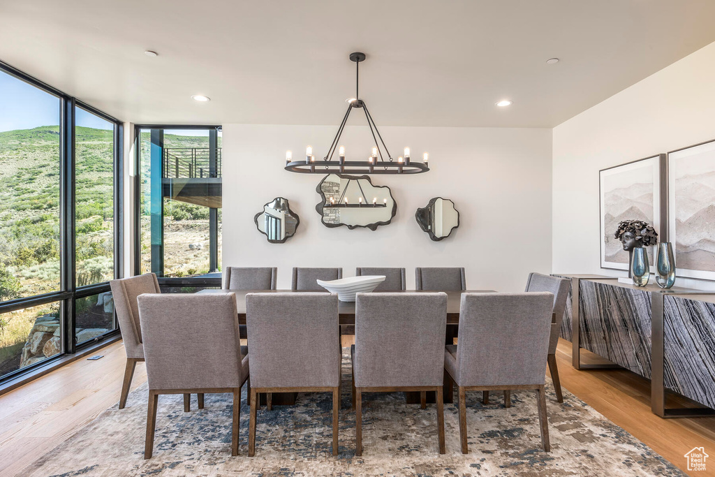 Dining room with expansive windows, a chandelier, and light hardwood / wood-style floors