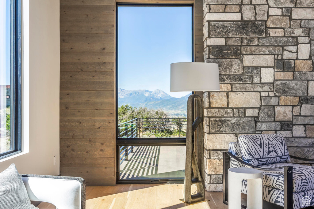 Interior space featuring hardwood / wood-style floors, a mountain view, and wood walls