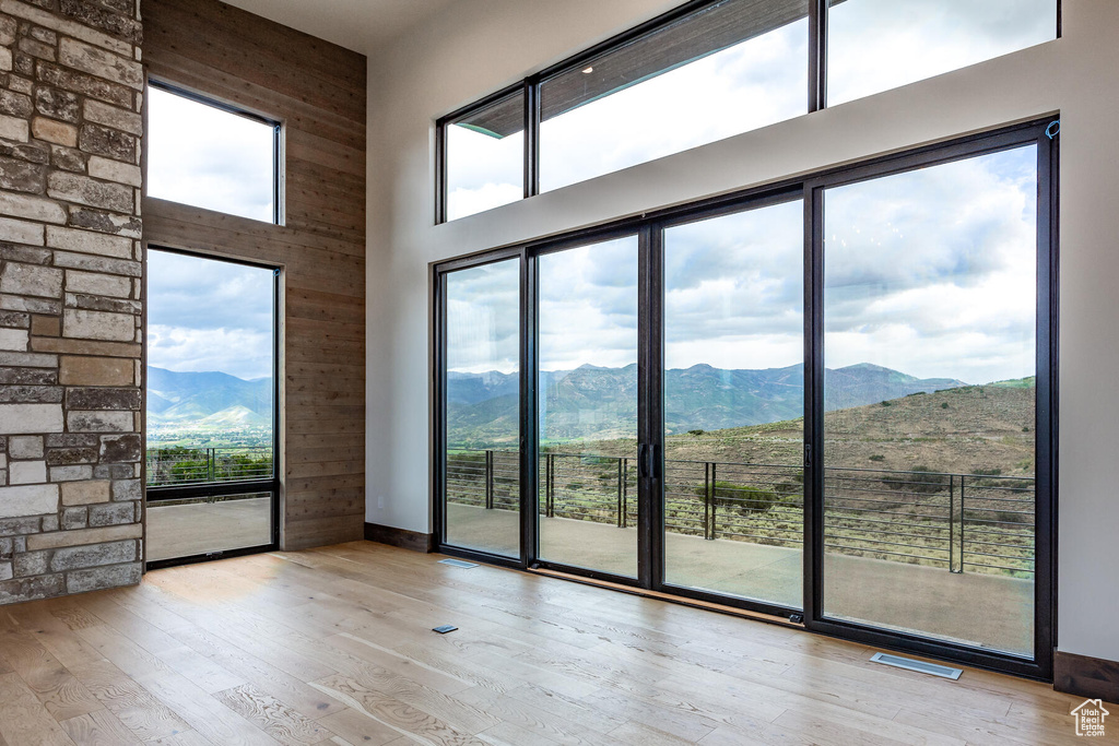 Entryway with a mountain view, a wealth of natural light, and light hardwood / wood-style flooring