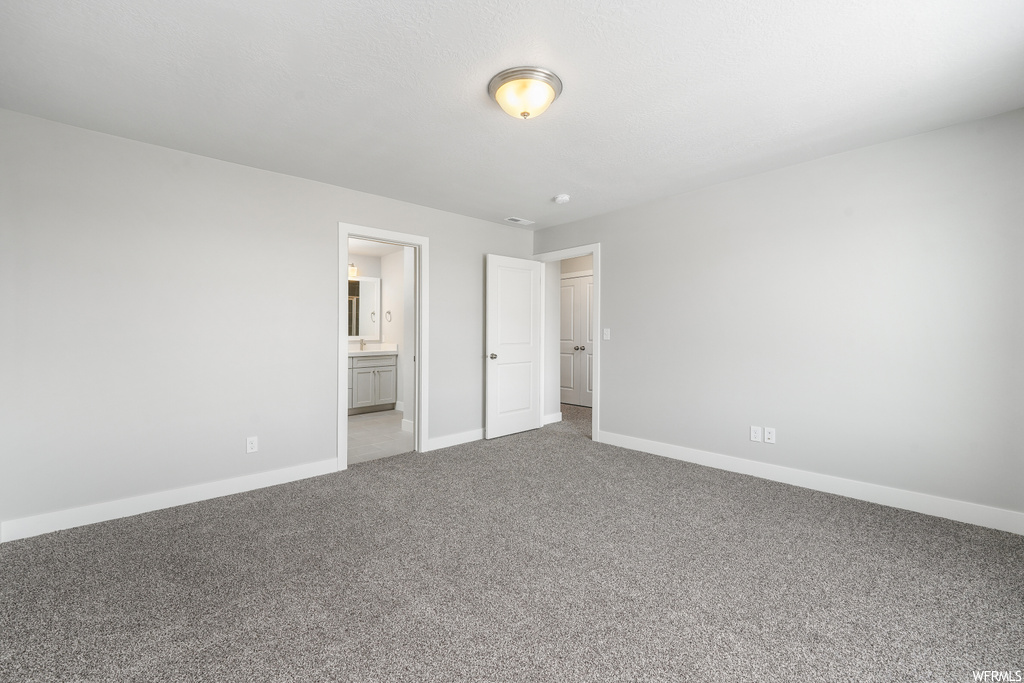 Empty room featuring light carpet