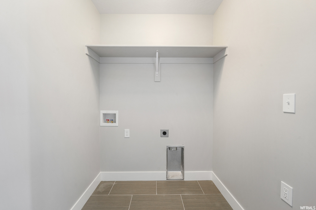 Laundry area with tile flooring