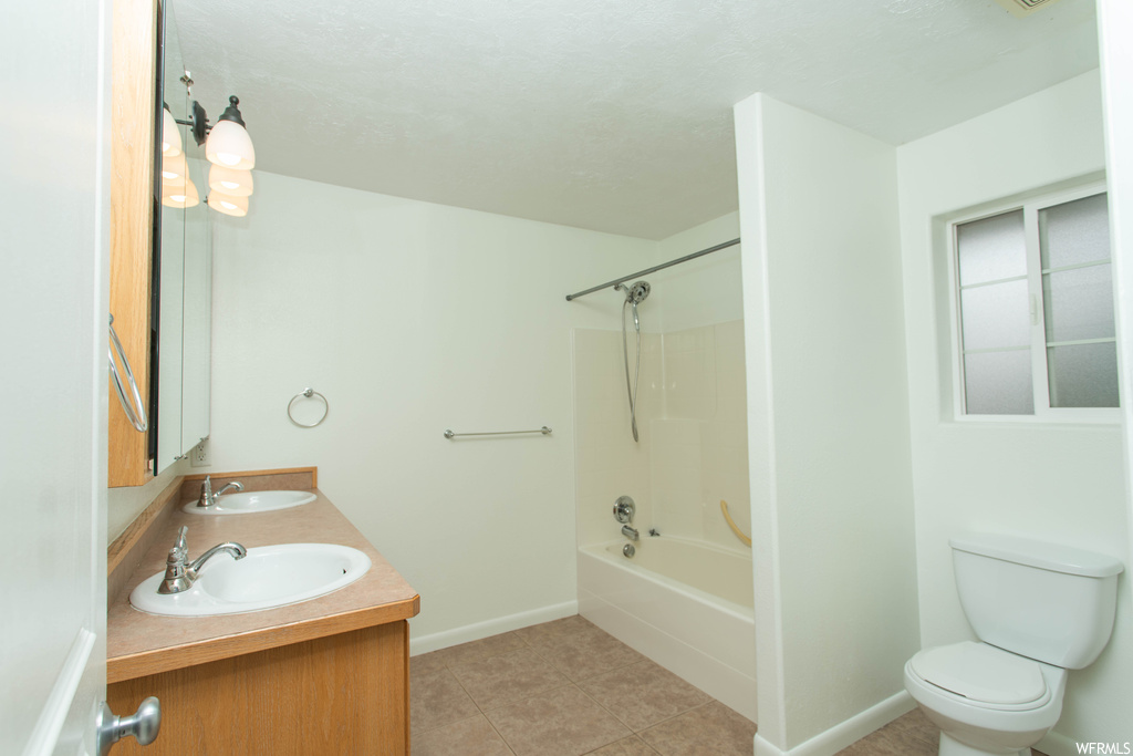 Full bathroom with dual vanity, shower / bathtub combination, mirror, and light tile floors
