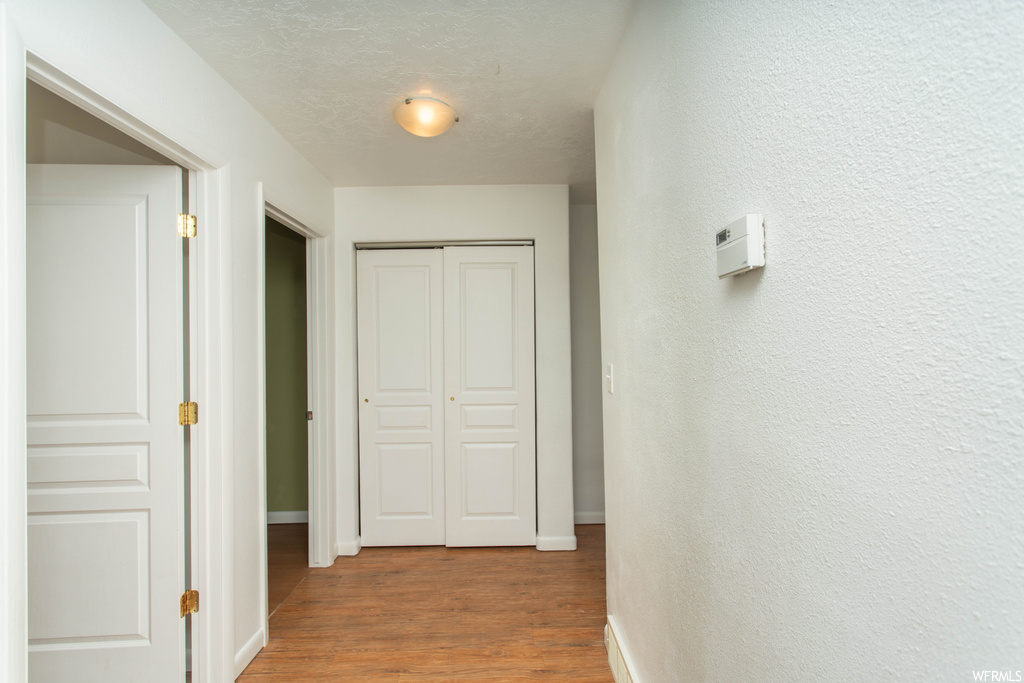 Corridor featuring light hardwood floors