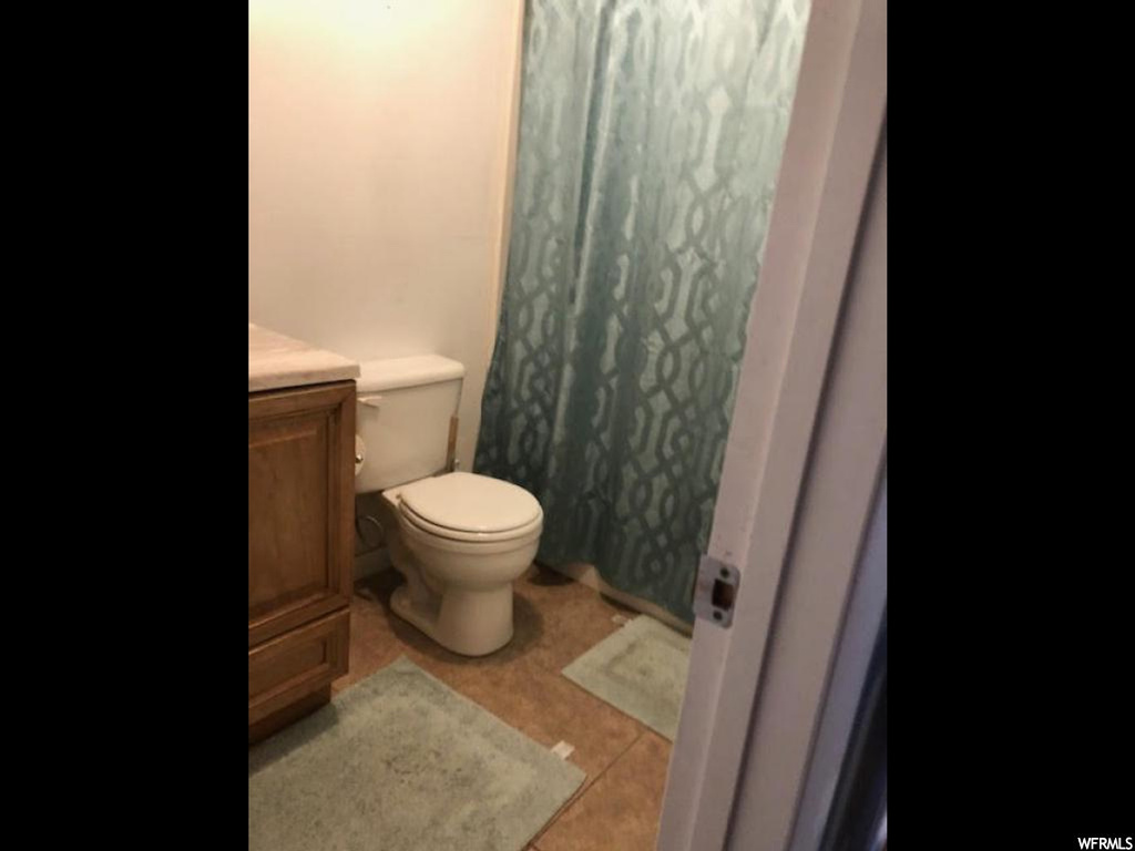 Bathroom with light tile floors and vanity