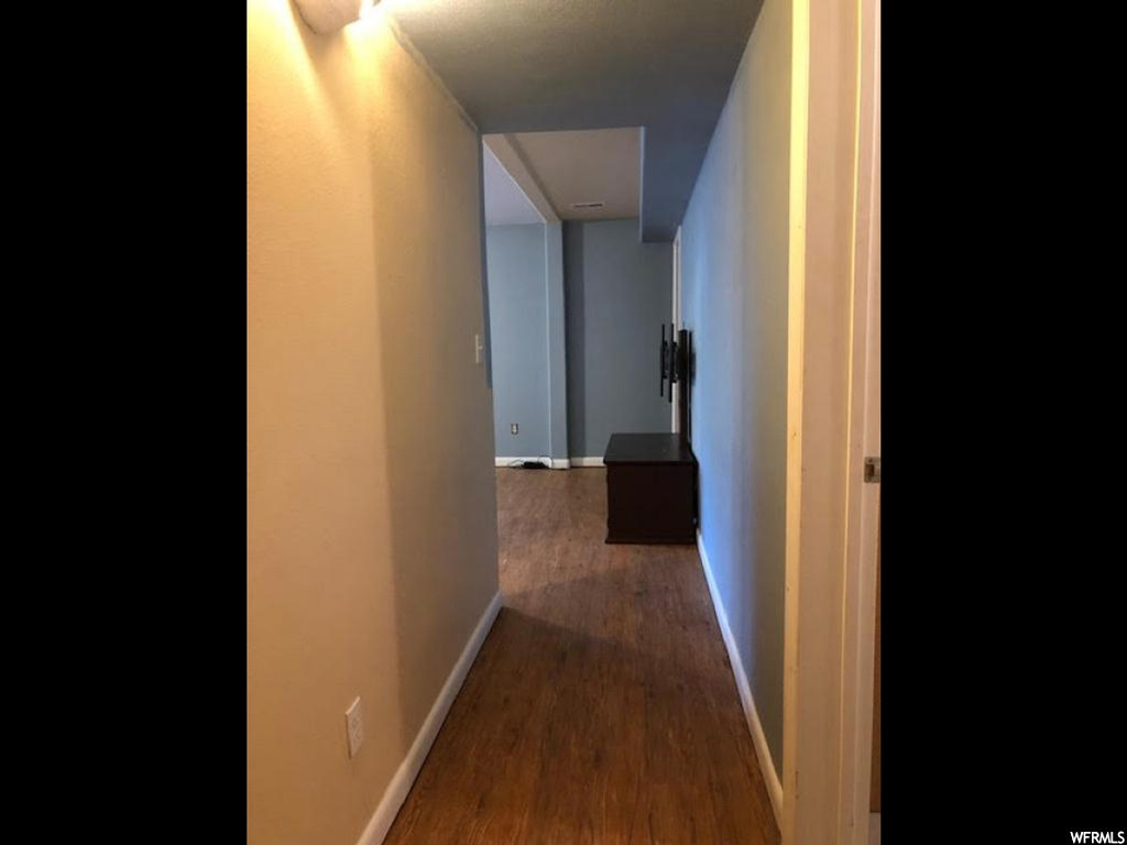 Corridor with dark hardwood floors