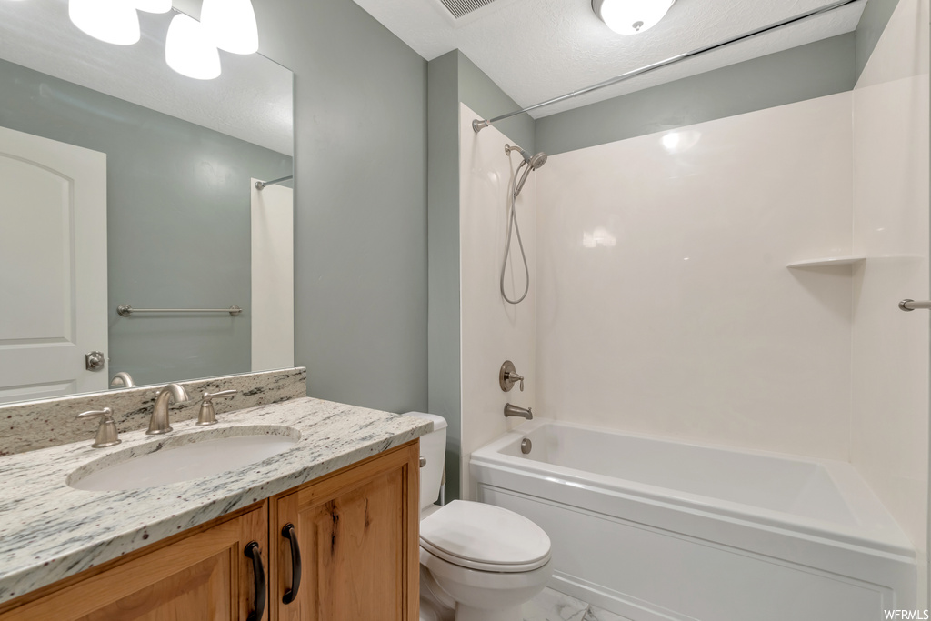 Full bathroom with shower / bath combination, mirror, and vanity with extensive cabinet space