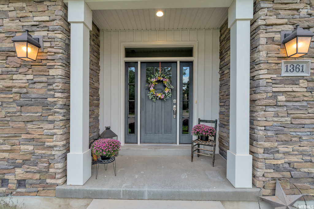 Doorway to property featuring a porch