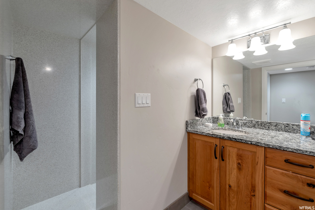 Bathroom with vanity and mirror