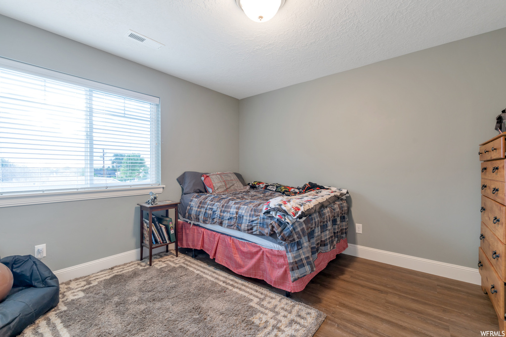 Bedroom with light hardwood flooring
