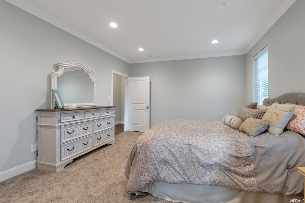 Bedroom featuring light carpet and crown molding