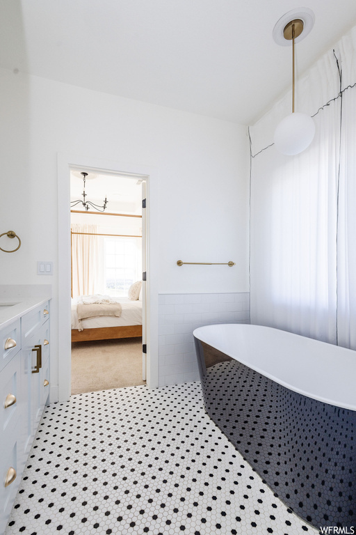 Bathroom featuring a bathing tub and vanity