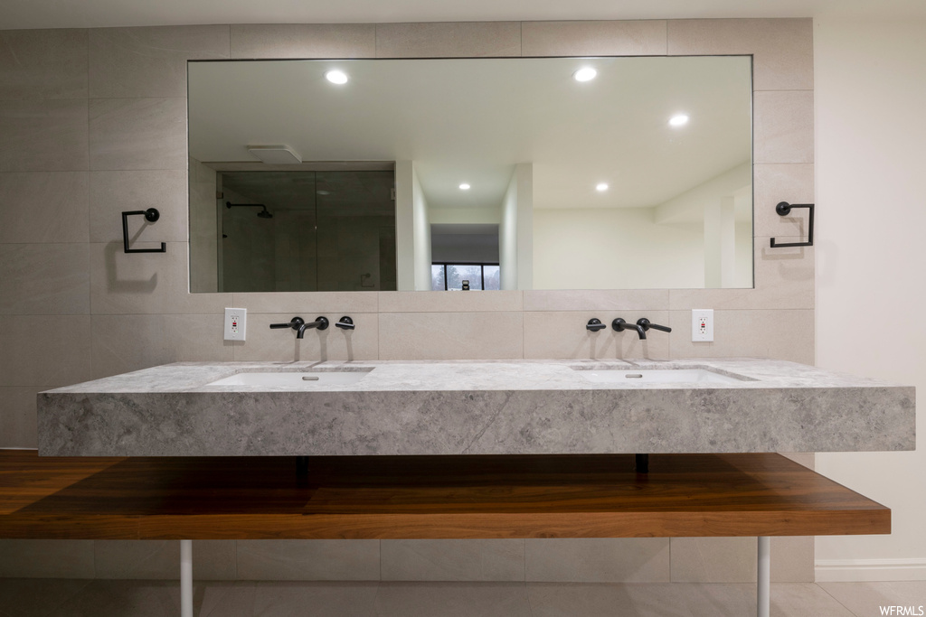 Bathroom with tile floors, dual large vanity, and mirror