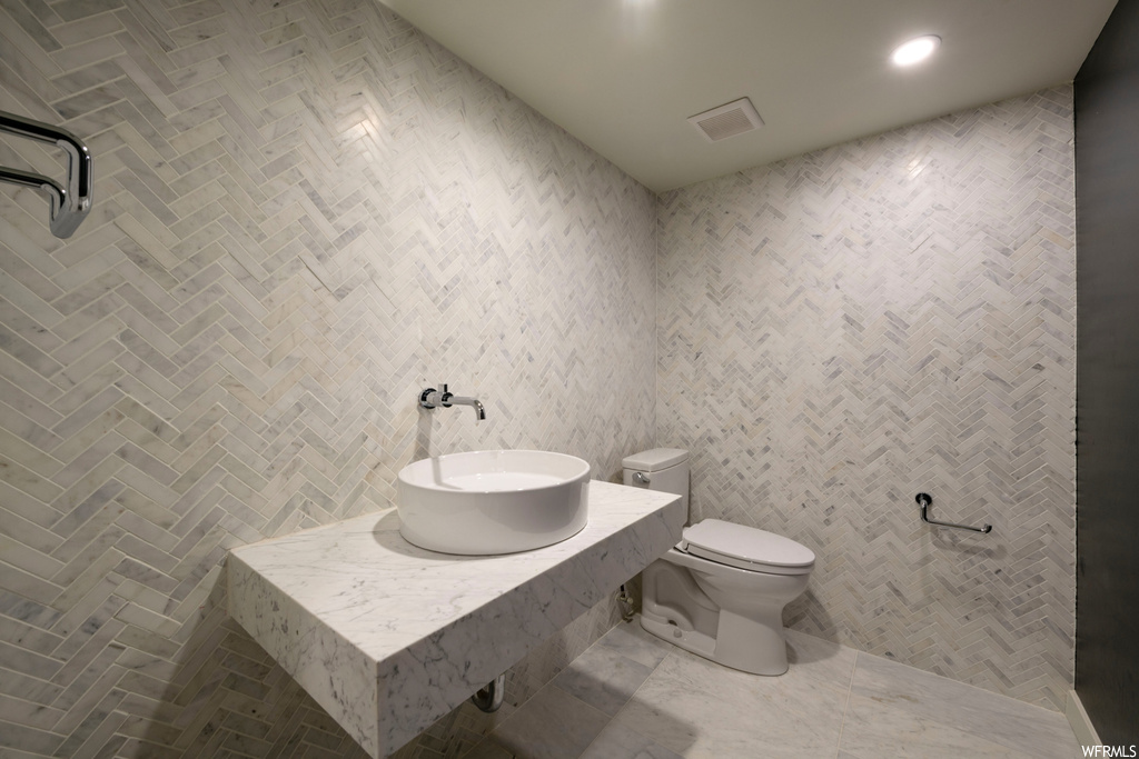 Bathroom with tile walls and vanity