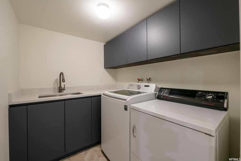 Laundry room featuring separate washer and dryer and light parquet floors