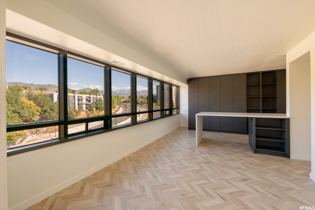 Interior space with light parquet flooring