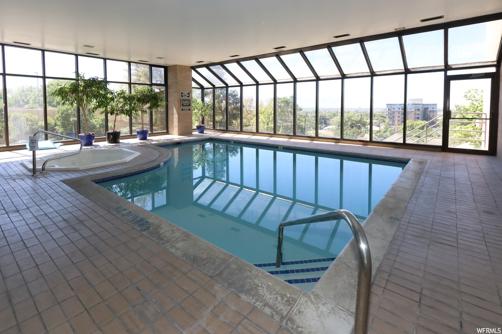 View of swimming pool with a patio area and a lanai