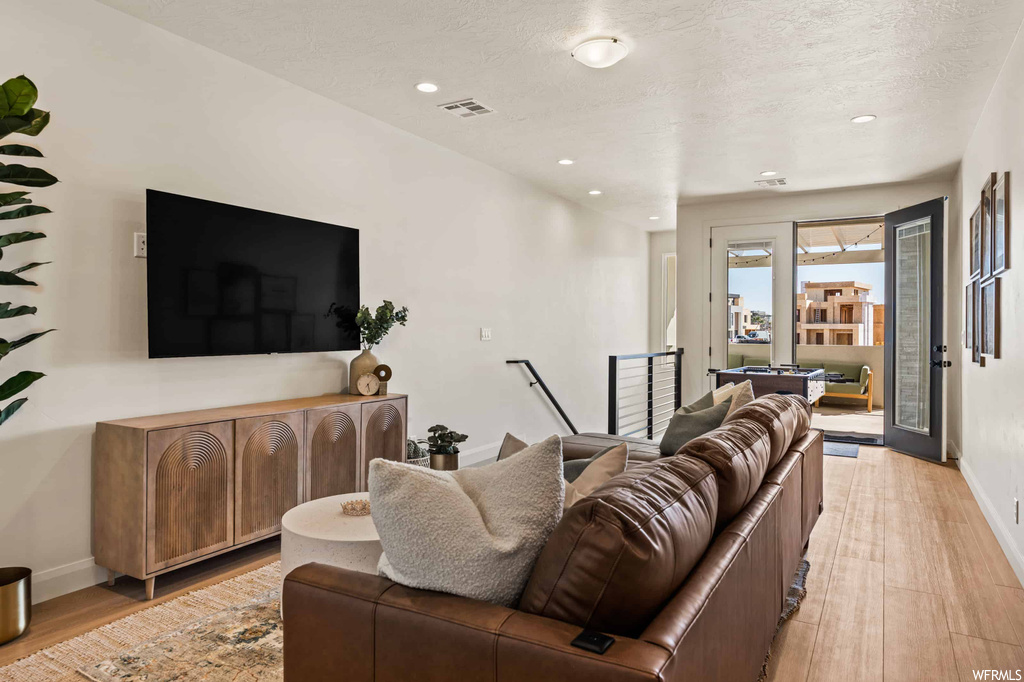 Hardwood floored living room with a textured ceiling
