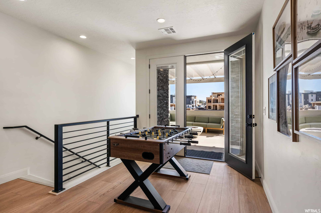 Interior space with a wealth of natural light and light hardwood flooring