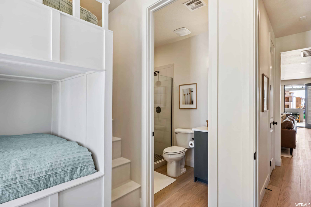 Bedroom with light hardwood flooring