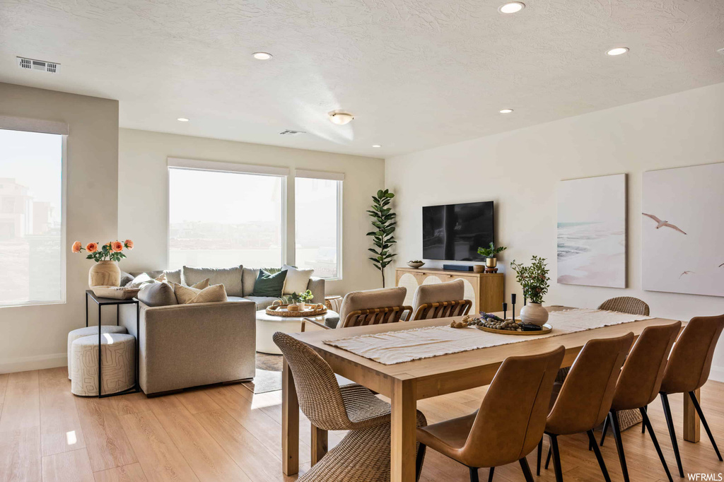 Dining area featuring a healthy amount of sunlight and light hardwood flooring