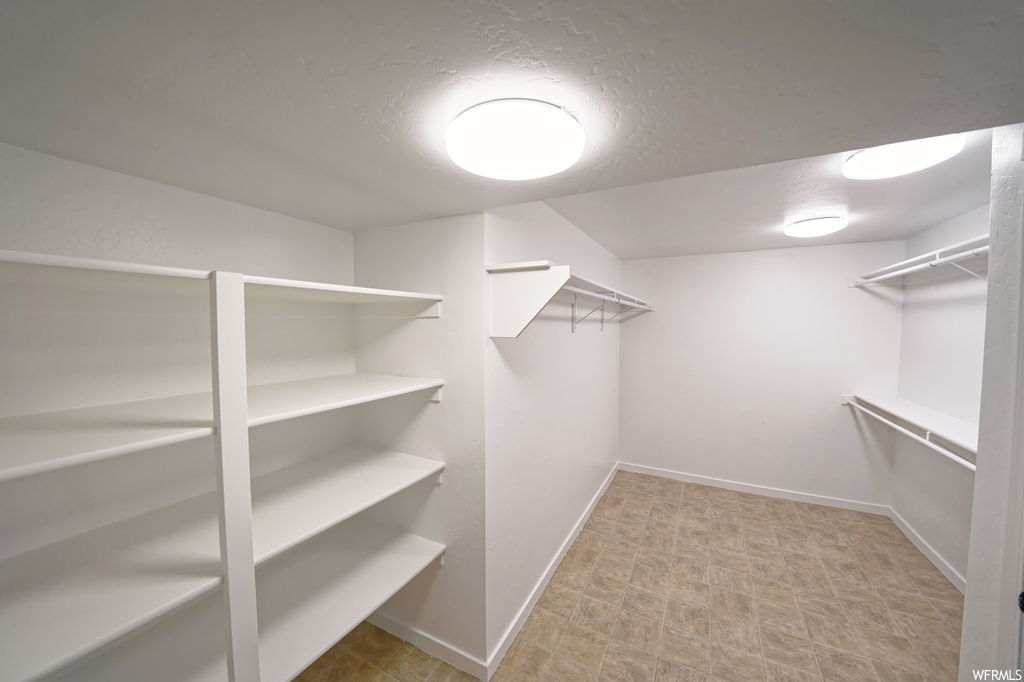 Spacious closet with light tile floors