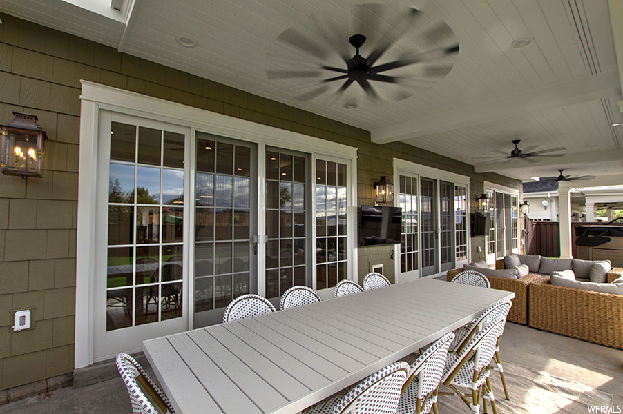 View of terrace featuring an outdoor living space and ceiling fan
