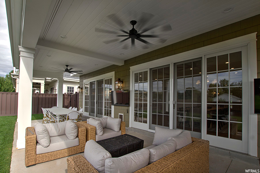 View of patio with an outdoor living space and ceiling fan