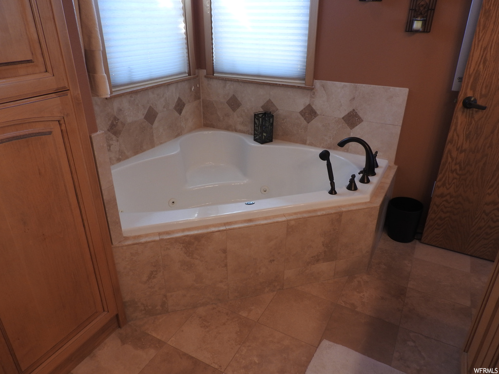 Bathroom with tile floors and tiled bath
