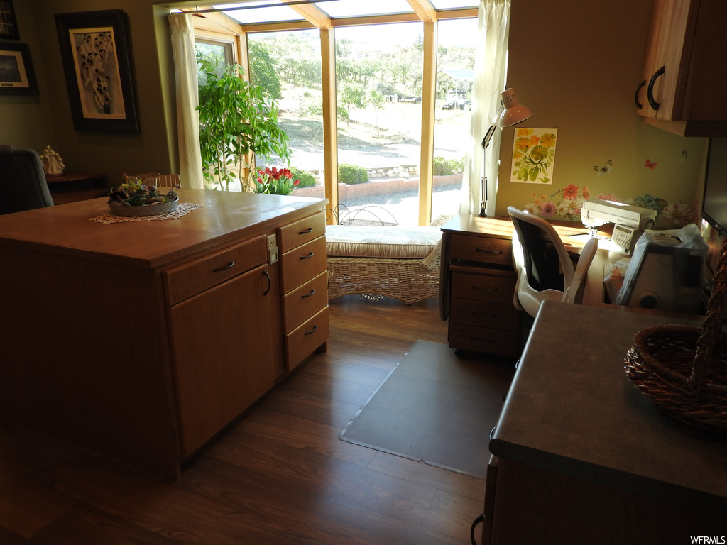 Kitchen with dark brown cabinetry and dark hardwood flooring