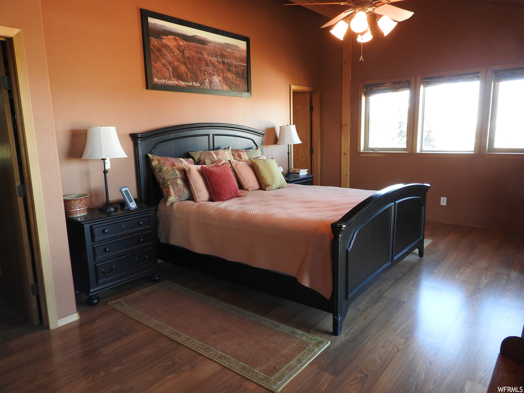Bedroom featuring ceiling fan and dark hardwood flooring