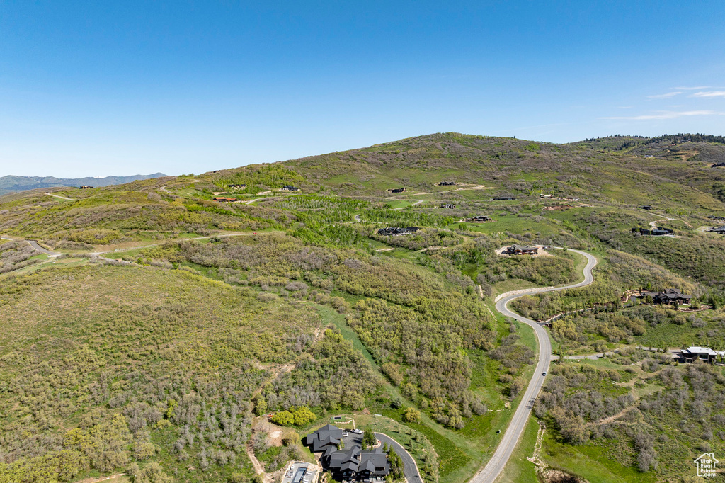 Aerial view of property and surrounding area with a mountain backdrop