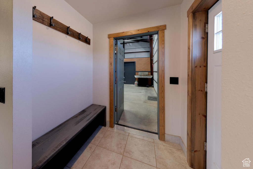 Corridor featuring light tile patterned floors