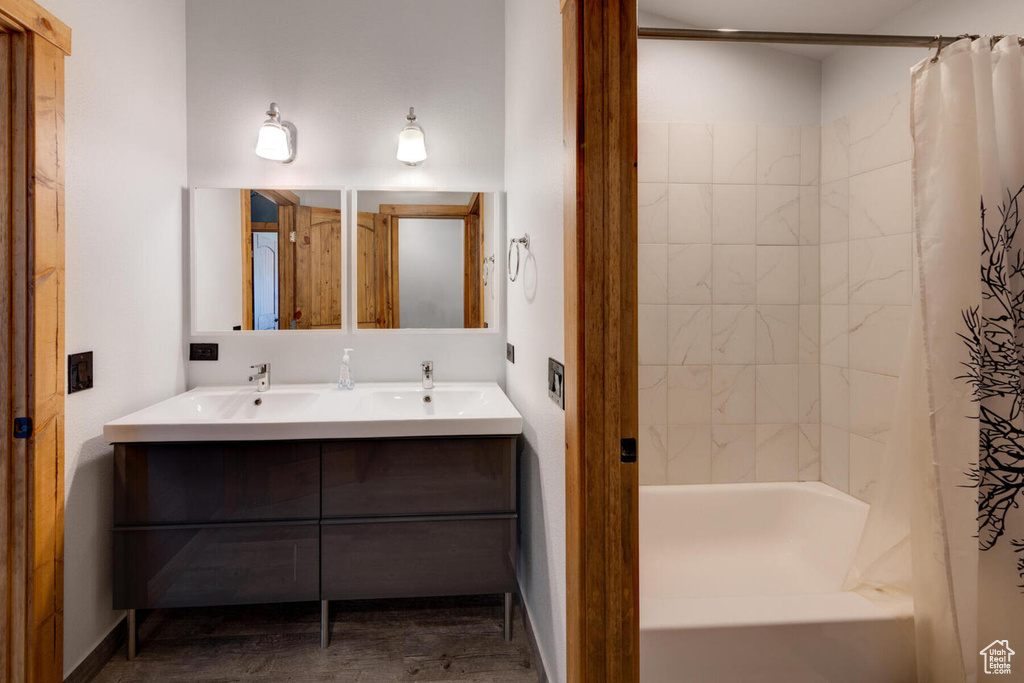 Bathroom featuring vanity and shower / bath combo with shower curtain