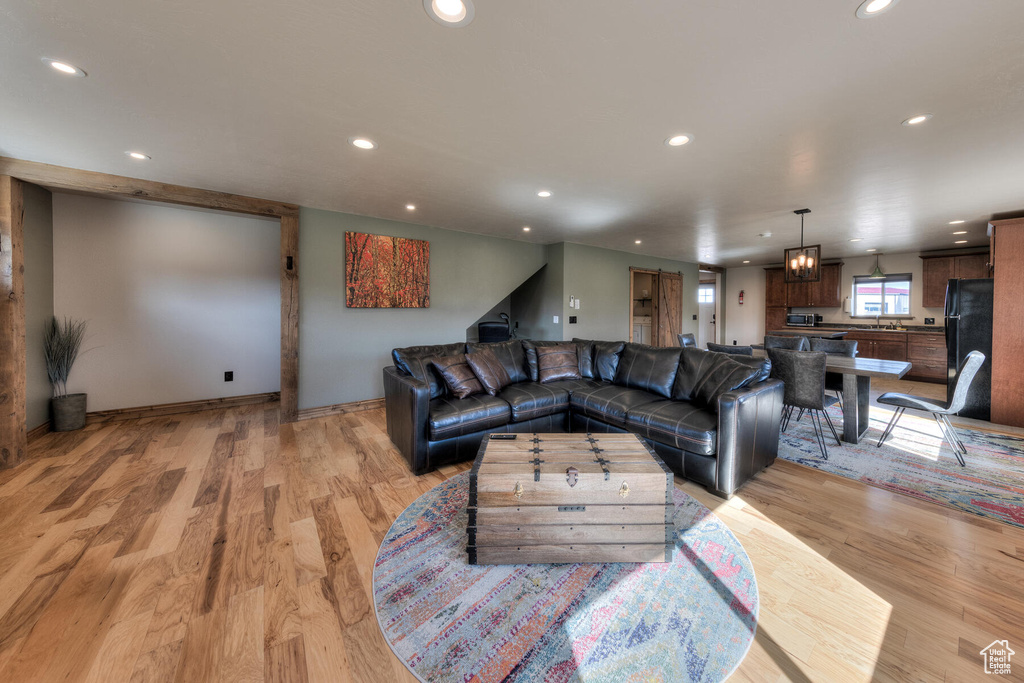 Living room with sink and light hardwood / wood-style flooring