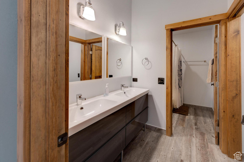 Bathroom with hardwood / wood-style flooring and vanity