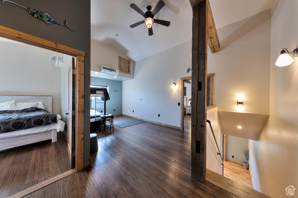 Bedroom with wood-type flooring, ceiling fan, and high vaulted ceiling