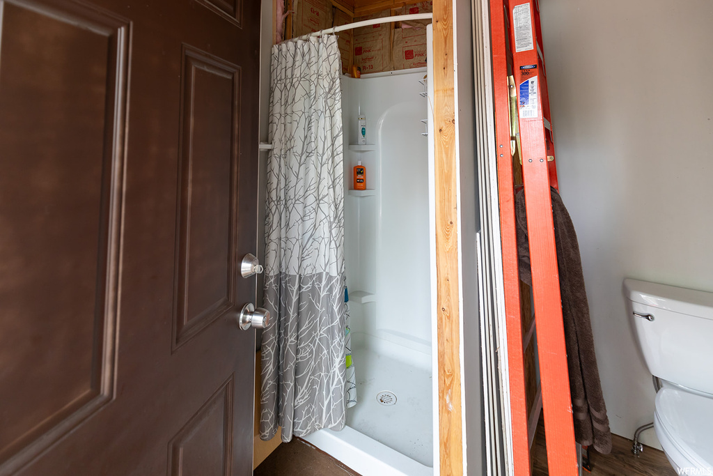 Bathroom featuring curtained shower