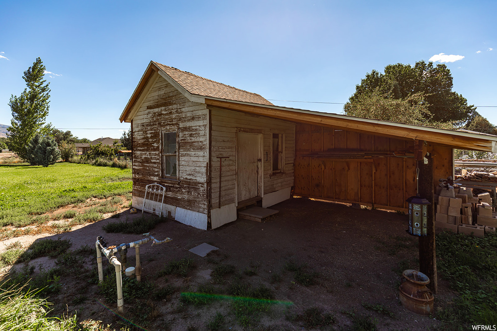 View of shed / structure featuring a lawn