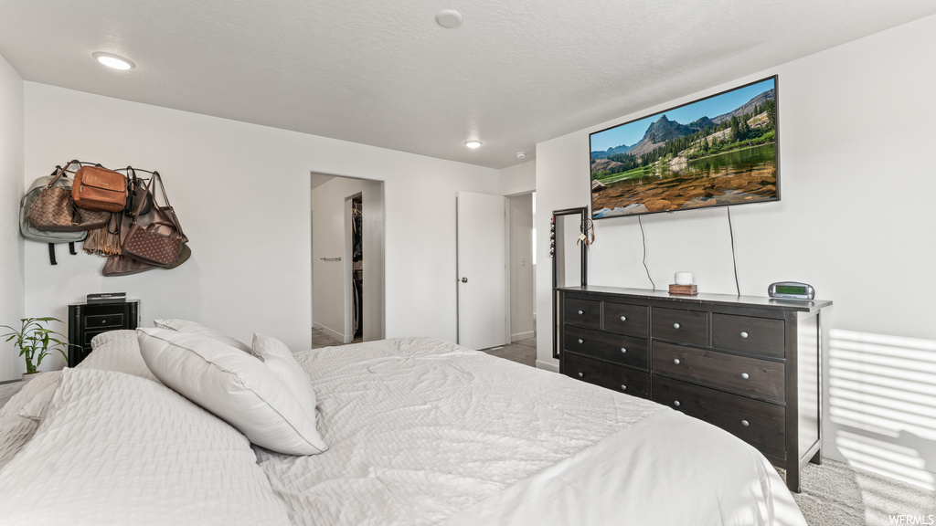 Bedroom featuring light carpet