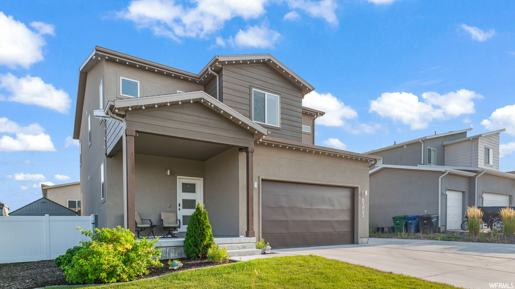 Front facade featuring garage and a front lawn