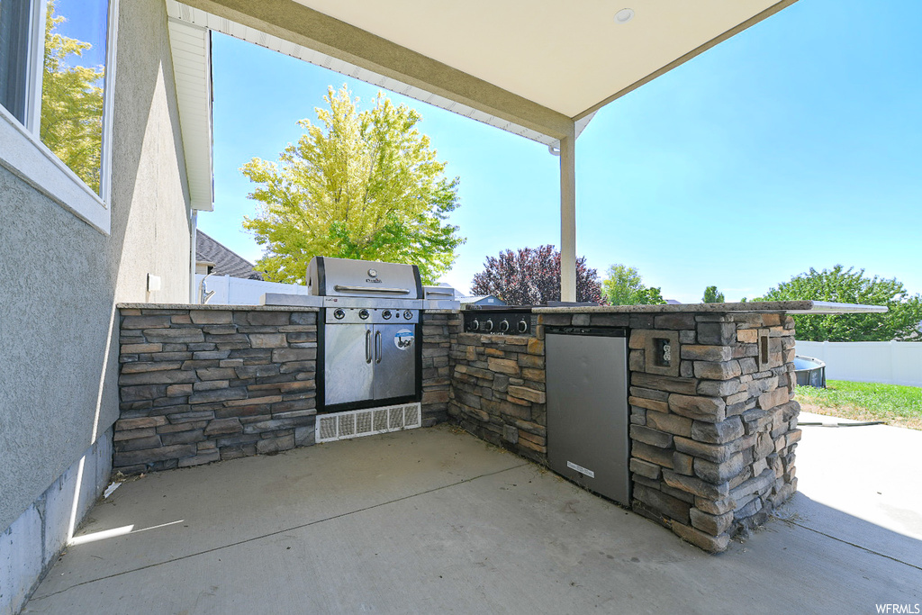 View of patio with an outdoor kitchen