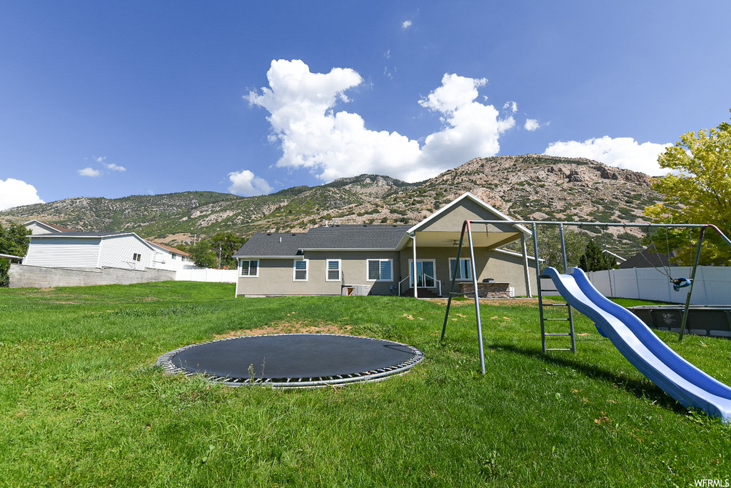 View of yard featuring a mountain view and a playground