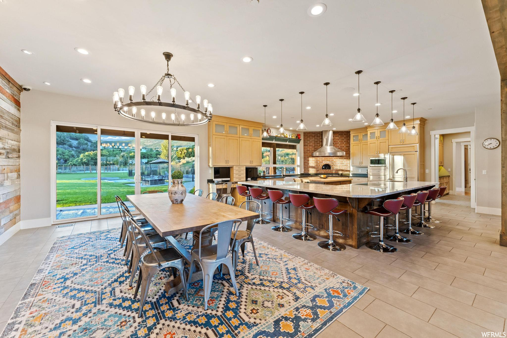 Tiled dining space featuring a chandelier